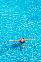 woman relaxing in infinity pool at luxury resort spa retreat.