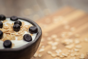 Yogurt. Stone bowl with fresh yogurt and berries on rustic table