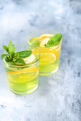 Fresh mojito cocktail on background. Coctail with lime and lemon. Place for text.