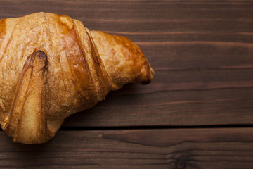 croissant on wooden background close-up