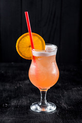 Sweet orange cocktail on black background
