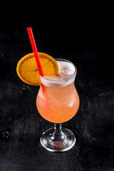 Sweet orange cocktail on black background