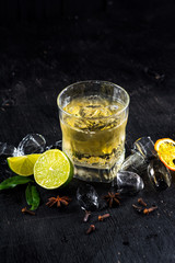 Yellow alcohol drink in glass on black background