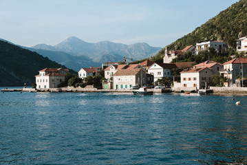 Fototapeta na wymiar City next to Blue Ocean and Mountains, Montenegro
