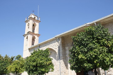 Fototapeta na wymiar High stone bell tower of the historic Christian Church