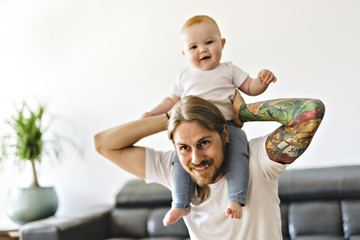 father playing with baby daughter on the living room