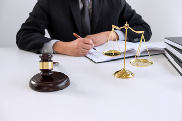 Close up of gavel, Male lawyer or judge working with Law books, report the case on table in modern office, Law and justice concept