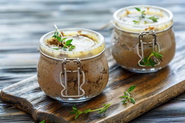 Beef liver pate with thyme in glass jars.