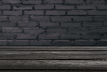 Selected focus empty black wooden table and wall texture or old black brick wall blur background image. for your photomontage or product display