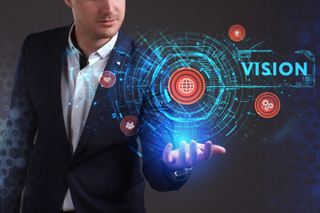 Business, Technology, Internet and network concept. Young businessman working on a virtual screen of the future and sees the inscription: Vision