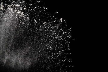 Bizarre forms of  white powder explosion against dark background. Launched white particle splashing.