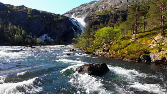 Norway landscape with waterfall, river and mountains. Hardangervidda National Park. 4K, UHD