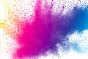 Multi color powder explosion on white background. Bizarre forms of  colorful dust particles splash on dark background.
