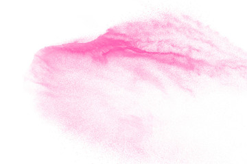 Pink color powder explosion on white background. Launched colorful dust particles splashing.