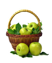 Basket of apples on a white background. Juicy green apples with leaves. Healthy eating. Gardening.