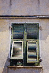 Fototapeta na wymiar Old colorful facade walls and windows grunge architectural background Italy