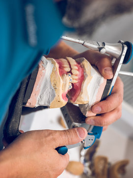 Dental technician making denture