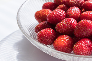 Fresh strawberries in a glass bowl. Healthy summer dessert