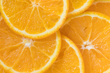 Fototapeta na wymiar Orange citrus fruit slices background. Close up