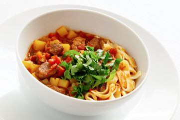 lagman decorated with parsley and cilantro