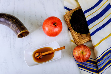 Pomegranate, apple and honey, traditional food of jewish New Year celebration, Rosh Hashana. over...