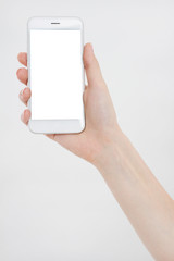 Hand holding white phone isolated on white clipping path inside. Top view.Mock up.Copy space.Template.Blank.