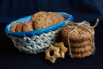 Savory cookies sprinkled with sesame seeds, sunflower on shale board