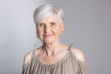 elderly woman on studio dark gray background