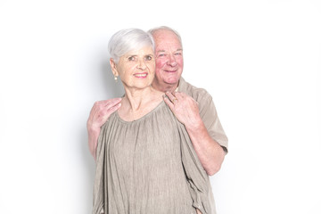 Senior couple posing on studio white background