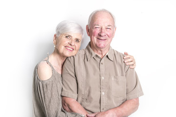 Senior couple posing on studio white background