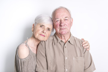 Senior couple posing on studio white background