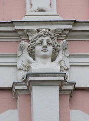 Fototapeta na wymiar The decor of the house in the form of a head of Mercury is located on the house of merchant Matvey Kuznetsov. The house was built by the architect Fyodor Shekhtel in 1898. Russia, Moscow, May 2018.