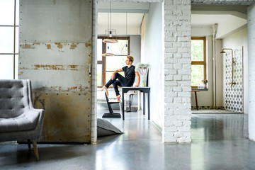 A young handsome Dancer relaxing in a loft style apartment