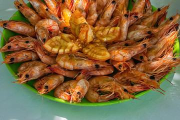 Delicious deep fried shrimp, on a green plate on a wooden table, copy space for text, view from...