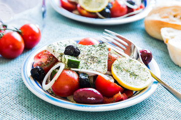 Greek salad plate with tomatoes, feta, olives and onions nice decoration