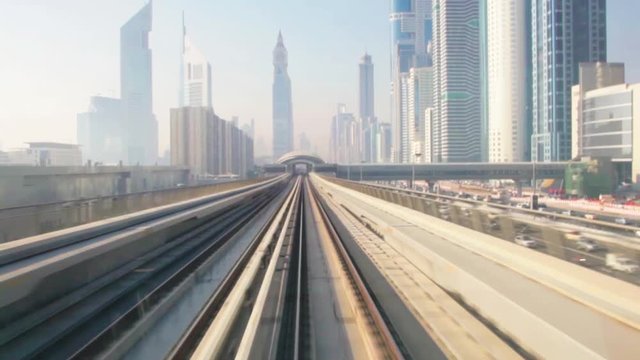 skyscrapers business center on blue sky background and Metro Train in Dubai, United Arab Emirates.