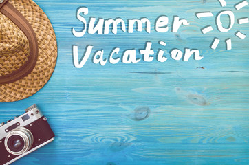 Summer vacation background with copy space. Tourist equipment on blue wooden table.