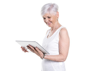 elderly woman on studio white background with tablet