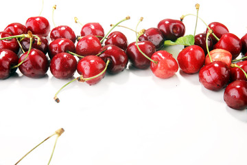 Cherry. Red fresh Cherries in bowl and a bunch of cherries on the table