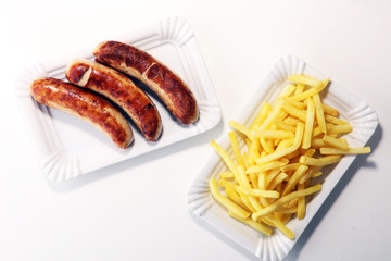 Grilled sausage served with french fries or fried potatoes with sausage
