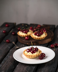 cherry tarts, bright cherries, rustic style, old wood, deep colours