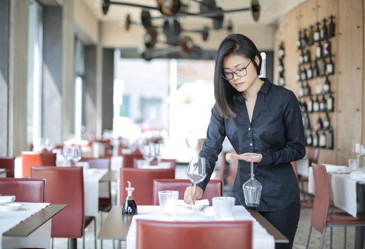 waitress preparing restaurant tables
