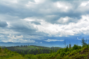 Mountain landscape - cloudy day, clouds and clouds. Against the background - Ukrainian mountain Goverla in the clouds.
