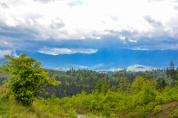 Mountain landscape - cloudy day, clouds and clouds. Against the background - Ukrainian mountain Hoverla in the clouds.