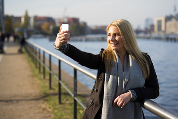 junge Frau macht Selfie an der Berliner Spree