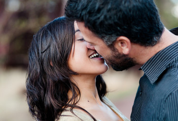 young couple in love, relaxed in a sunny day in the forest