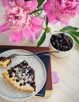 A Slice Of A Berry Pie On A White Plate, Cookbooks And A Bouquet Of Peonies.