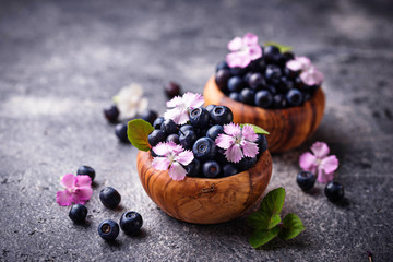 Fresh ripe blueberries in wooden bowl