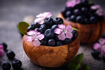 Fresh ripe blueberries in wooden bowl