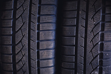 Protector of automobile tires. A number of automobile tires. Close up view on auto mobile new wheel tire surface. Different pattern and type tires for car industry commercial transport transpotration